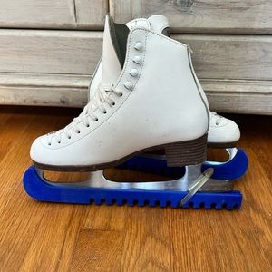 White leather Riedell ice skates.
